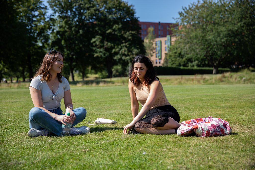 2 people sat in Peel Park