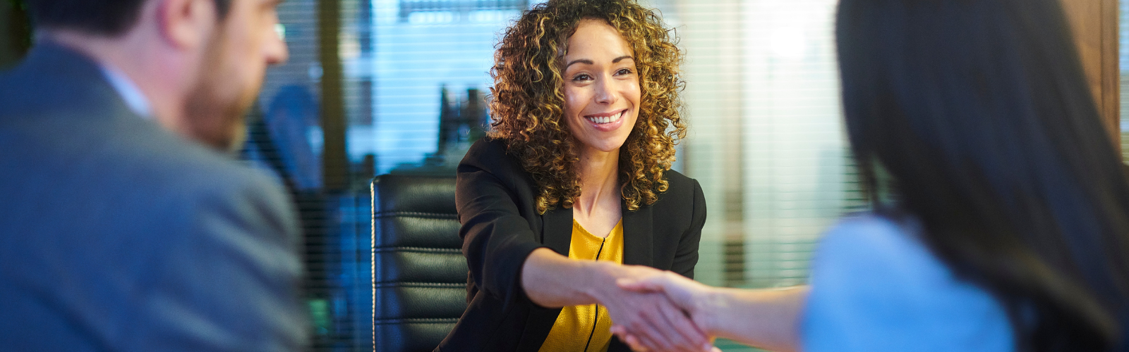 An interview candidate shaking hands with a member of the interview panel