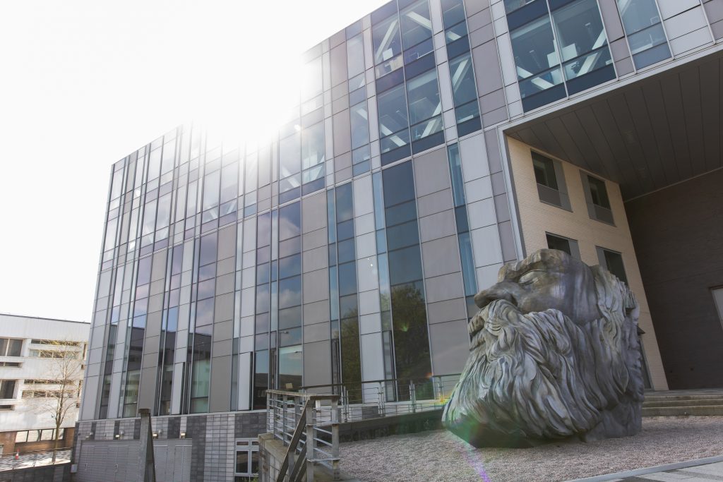 Photo of the outside of the New Adelphi building featuring the statue of Friedrich Engels head