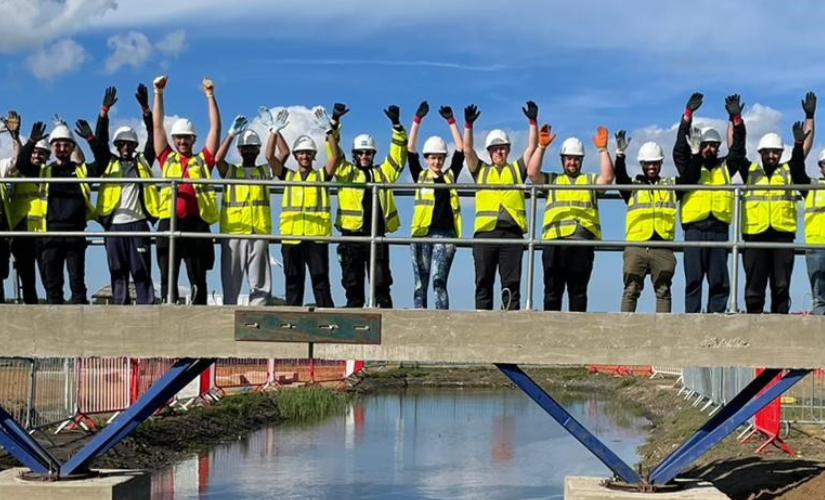 Students on a bridge at construction site at constructionarium