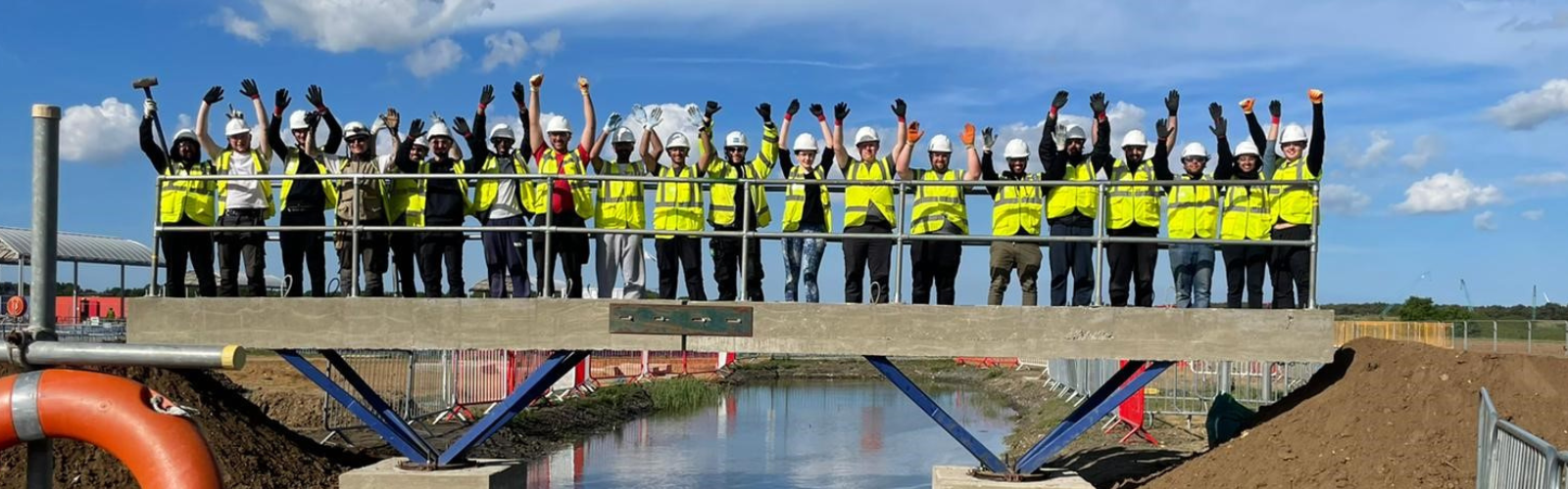 Students on a bridge at construction site at constructionarium