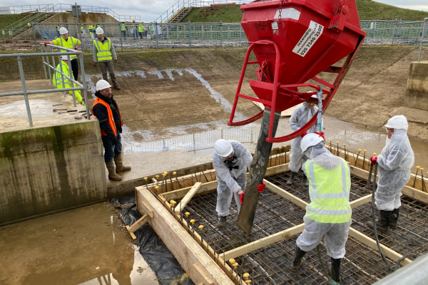 students working in a group and using a specialist equipment on site