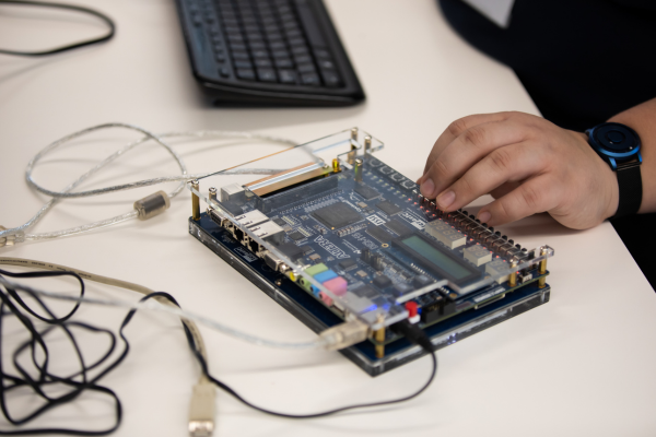 Students using electronic engineering equipment to monitor measurements