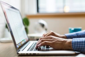 A person typing on the laptop