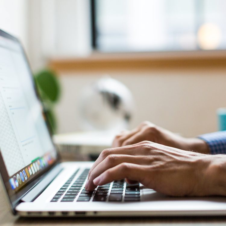 A person typing on the laptop