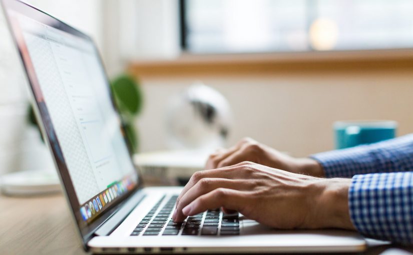 A person typing on the laptop