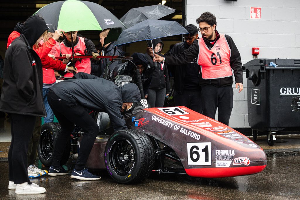 Jonathan leading the team and surrounding the car