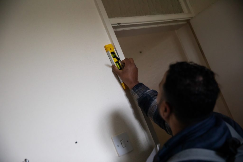 Student using equipment to measure distance of home 