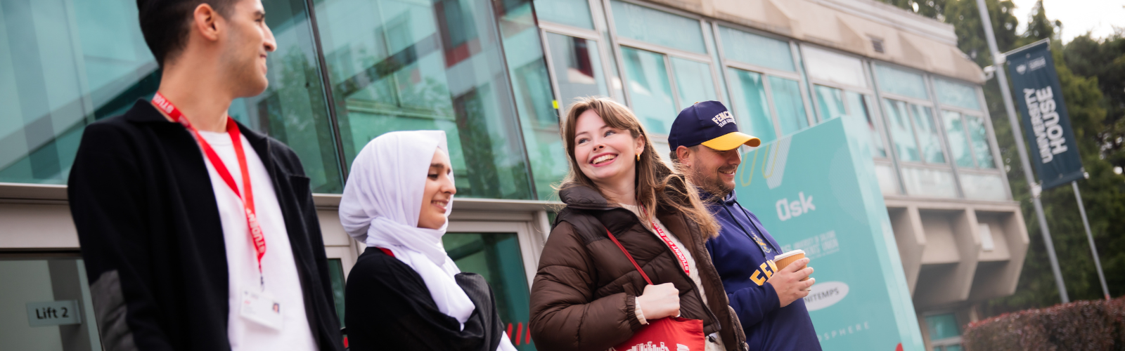 Four students leaving University House on Peel Park campus