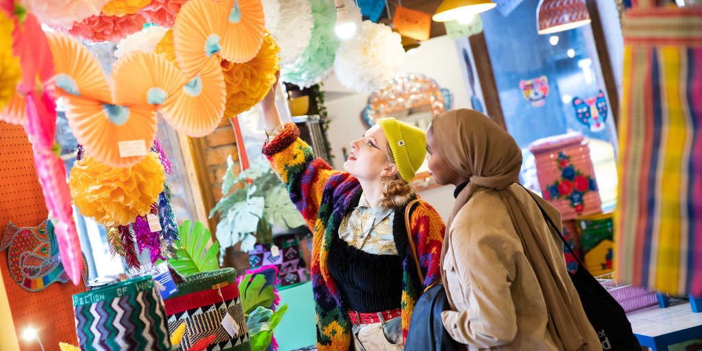 Two students browsing a shop in Manchester