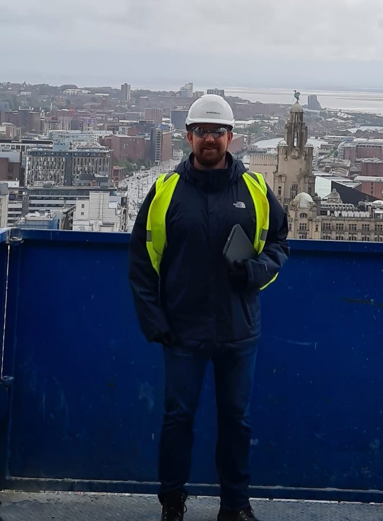 Student Chris in construction PPE at a viewpoint