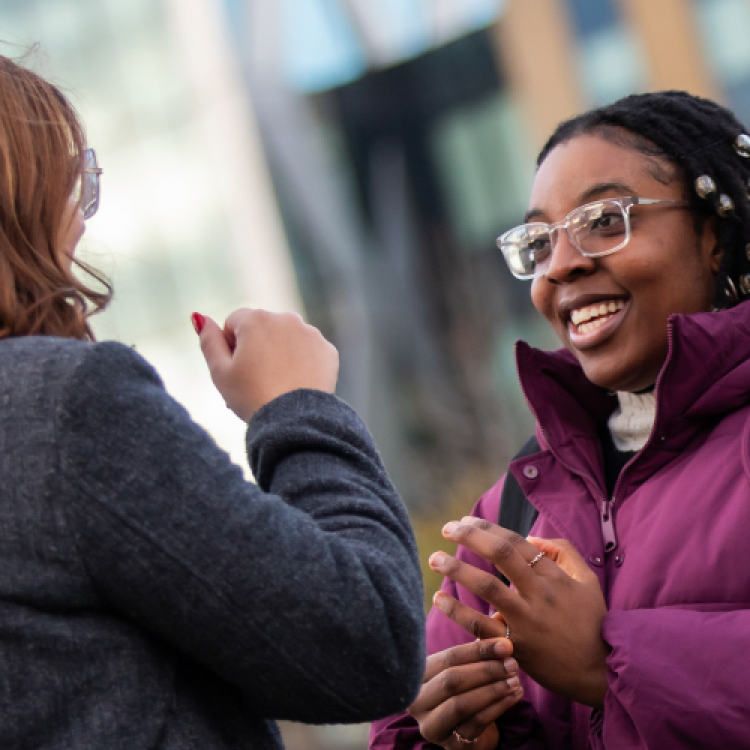 Two students chatting at Salford Quays