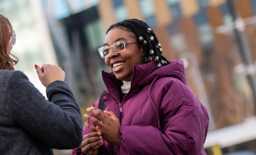 Two students chatting at Salford Quays