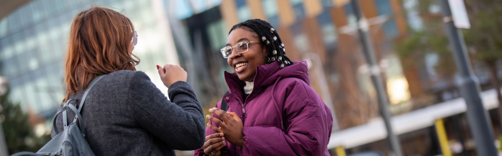 Two students chatting at Salford Quays