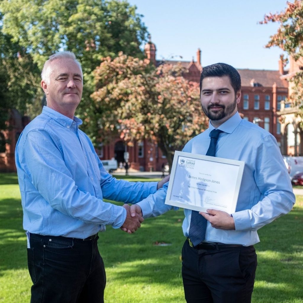 A photo of James Hodgson-Jones receiving and award