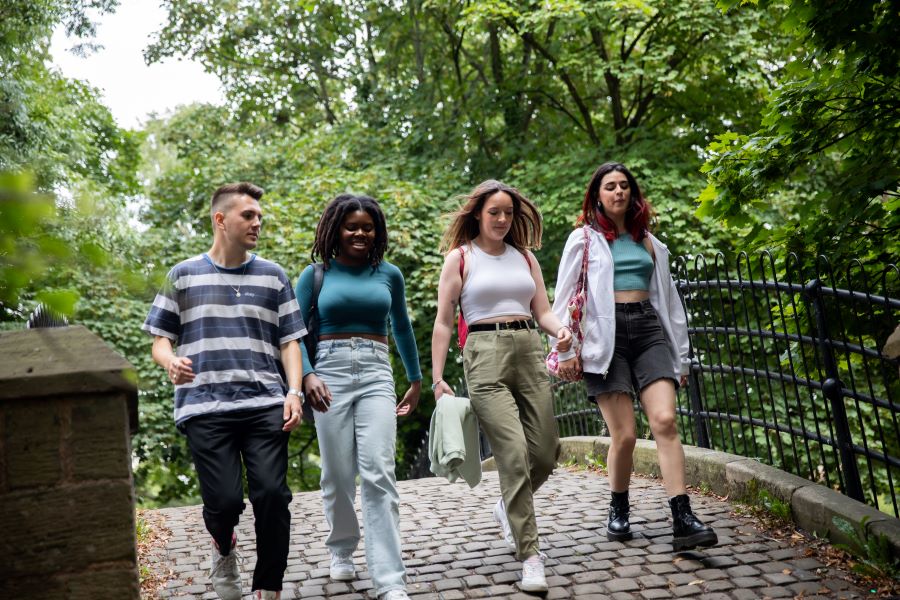 Four students connecting via a walk through Worsley.